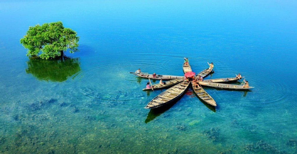 Wooden boats on a clear Sylhet lake