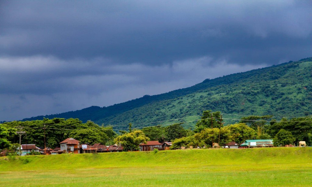 Village at the foot of green hills